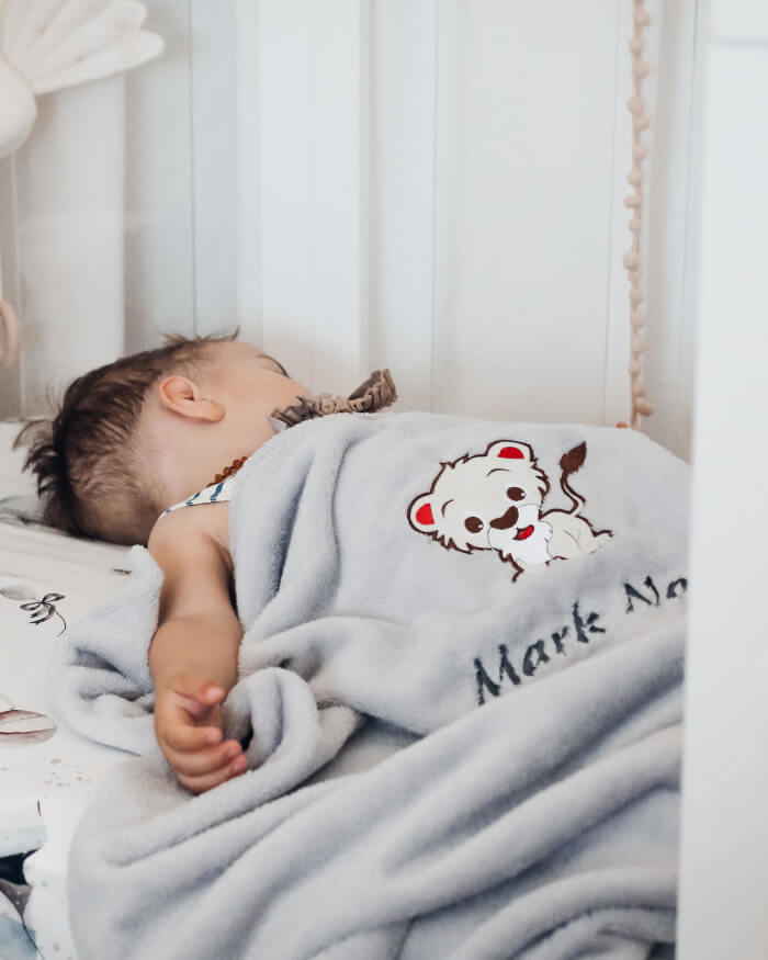 Dječak Mark Noa spava pokriven svojom personaliziranom dekicom.